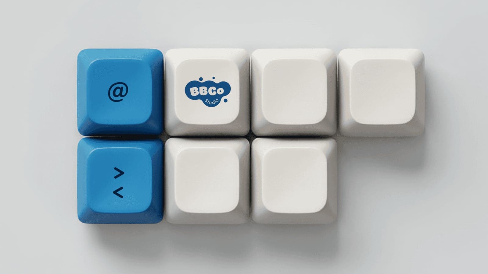 Keycaps with the BBCo Studio logo, an @ sign and code brackets